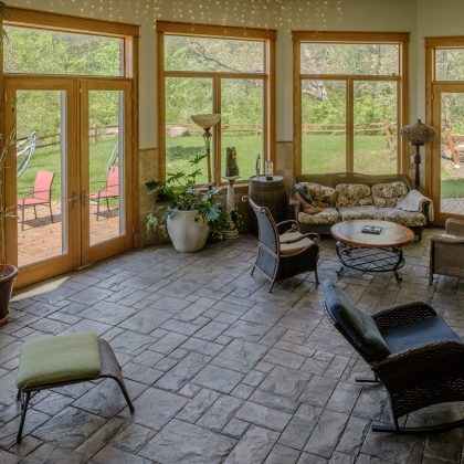 Bright, airy atrium interior at Top of the World Ranch addiction rehab facility, filled with natural light and serene views to promote peace and emotional wellness during recovery.